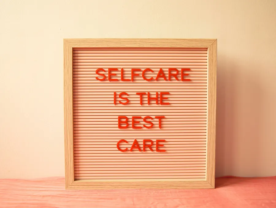 A letter board reading "Self-care is the best care"