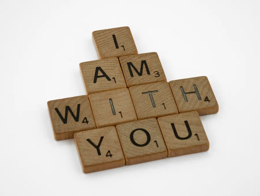 Wooden letter tiles spelling "I am with you"